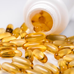 Heap of Omega 3 capsules on a white background. Top view, high resolution product. Fish fat.