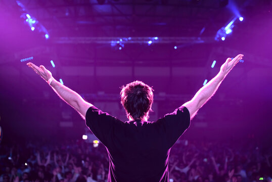 Dj At The Party Stage With Hands Up