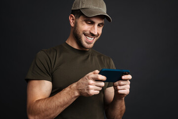 Confident young happy man holding mobile phone
