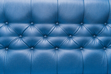 Blue leather upholstery sofa with pattern button design furniture style decor texture background
