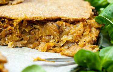 freshly baked cabbage pie on rustic wooden background