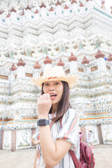 Women wear summer hat walking to travel in temple of dawn Wat Arun