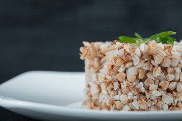 Delicious buckwheat with greens on a white plate