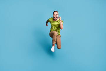 Fototapeta na wymiar Full size photo of crazy attractive funky man run jump up you sale travel isolated on pastel blue color background