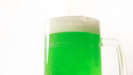 A pint of green beer for st patrick's day on a white background. Traditional Irish drink for a holiday