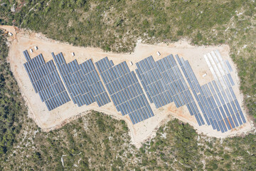 Aerial overhead drone shot of solar panels on hill near Zena Glava village on Vis Island in Croatia...