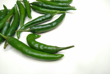Spicy green chilli peppers isolated on white background