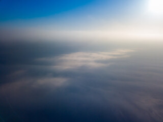 Flight high above the clouds. Aerial drone view.