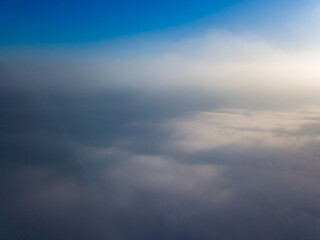 Naklejka na ściany i meble Flight high above the clouds. Aerial drone view.