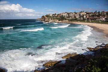 beach and sea with houses in the distance