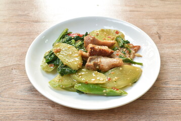 stir fried Chinese kale with crispy pork in soybean sauce on plate