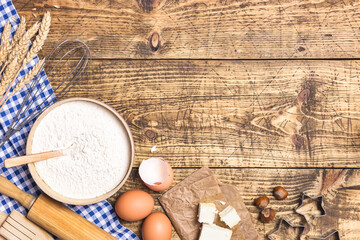 Baking and cooking ingredients on rustic wooden background