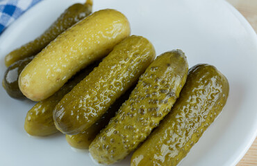 A white plate of delicious pickled cucumbers