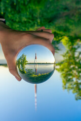 View across the river to the TV tower seen through a glass ball.