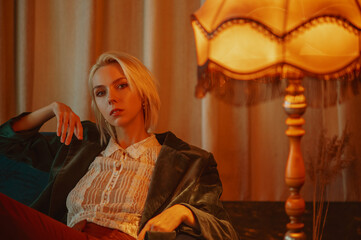 Elegant fashionable woman wearing luxury outfit, posing in vintage interior. Copy, empty space for...