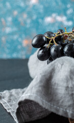 Dark fresh grape in basket on a colorful background