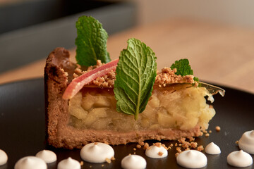 Delicious cake for desert in restaurant on a wooden table, no people are visible. Tasty food with coffee in cafe menu.