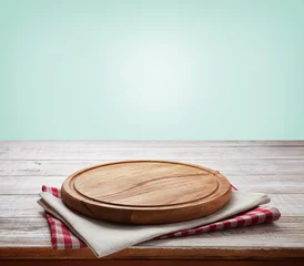 Poster Napkin and board for pizza on wooden desk. Kitchen background. © missty