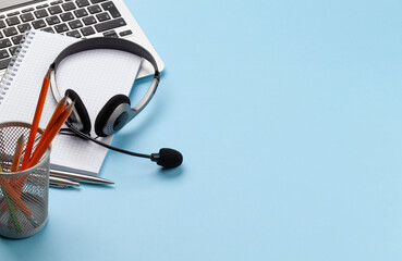 Office desk with headset and laptop. Work from home
