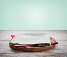 Napkin and board for pizza on wooden desk. Kitchen background.