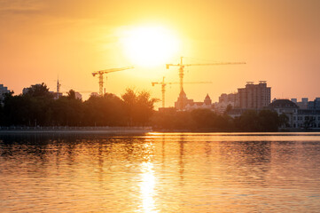 Building construction site, tall skyscrapers and cranes.