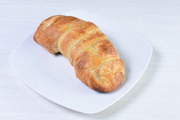 Freshly baked bakery displayed on white wooden background