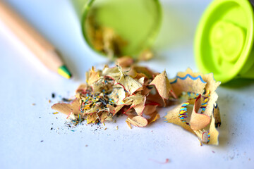Pencil and sharpener with garbage on a white background