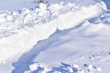 Fototapeta na wymiar Winter white snowy paths during the day