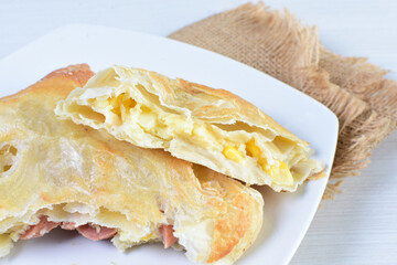 Freshly baked bakery displayed on white wooden background