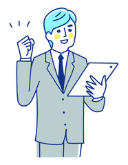 タブレット端末を持ってガッツポーズをするビジネスマン