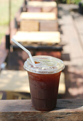 Iced americano coffee with ice on table at cafe.
