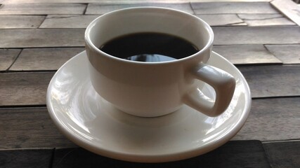 A Cup of Black Coffee on a Wooden Table for refreshment in the morning