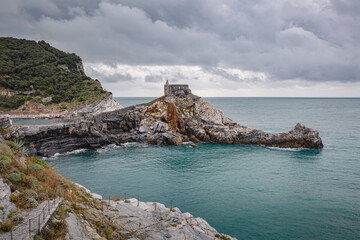 Portovenere (Porto Venere) in Liguria, Italy: beautiful aerial scenic view of the Church of St. Peter (Chiesa di San Pietro) from Doria castle nearby Cinque Terre