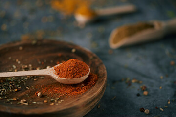 wooden spoon full of red curry powder