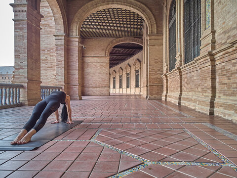 girl doing yoga in the Plaza de España in Seville