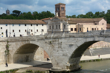 Fototapeta premium Isola Tiberina is the only urban island of the Tiber, in the center of Rome. It is connected to the two banks of the Tiber by Ponte Cestio and Ponte Fabricio.