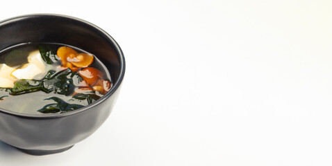 Miso soup in a black carriage. Ingredients Broth, Tofu cheese, Naimeko mushrooms, miso paste, hondashi, wakame. For restaurant menu