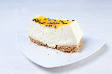 Yellow colorful passion fruit fluffy dessert on white wooden background
