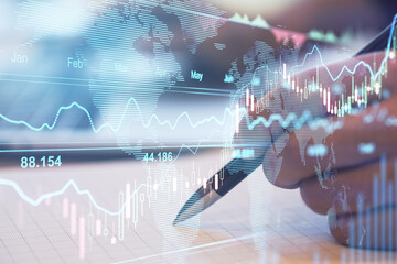 Stock market analysis concept with digital transparent screen with financial forex graphs and man hand with pen at background