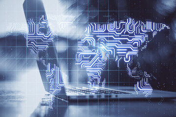 Big data online concept with opened laptop and transparent digital dispaly with glowing microchip world map