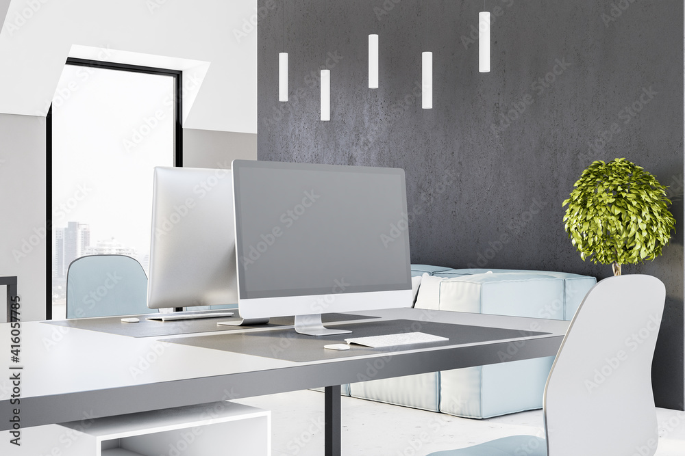 Poster blank grey computer monitor on modern table in light office with grey wall and city view. mockup