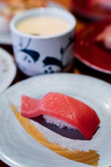 Sushi and Sashimi. Dishes of Sushi and Sashimi rolling on conveyer belt.