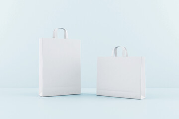 Blank white eco paper bags with a space for your logo at blue background. Mock up