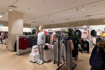 Modern fashionable brand interior of men and women clothing shop store inside shopping center