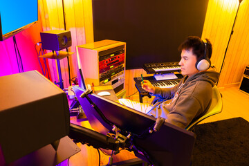 asian male DJ, producer enjoy working and listening music in broadcasting, recording studio