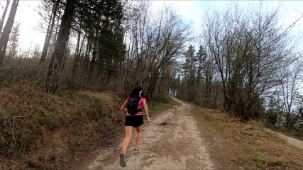 young woman trail running in the mountains