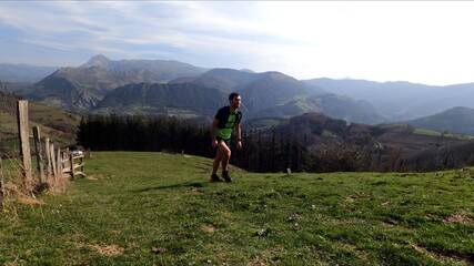 Fototapeta na wymiar young man trail running in the mountains