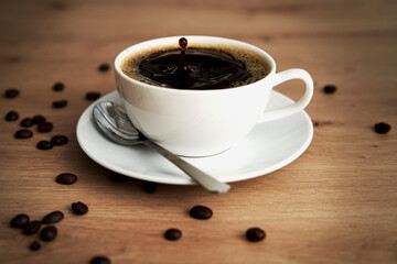 Espresso coffee cup on table with roasted coffee beans