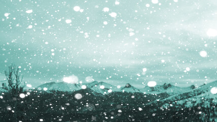 Beautiful winter blurred background of mountains with falling snow