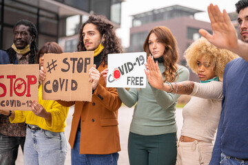 anti quarantine protest, multiethnic group of young people demonstrating against lockdown and...